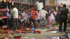 A group of people grabs toys as a store is ransacked by a crowd in the port of Veracruz, Mexico, Wednesday Jan. 4, 2017. Protests over a sharp gasoline price hike erupted into looting of gas stations and stores in various parts of Mexico on Wednesday, with dozens of businesses reportedly sacked. In the Gulf coast state of Veracruz, store guards were overrun by crowds who carried off clothing, toys, food, washing machines, televisions, DVD players and refrigerators.(AP Photo/Ilse Huesca)