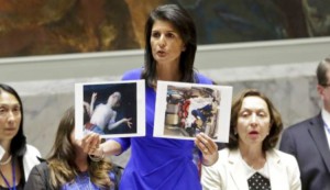 United States U.N. Ambassador Nikki Haley shows pictures of Syrian victims of chemical attacks as she address a meeting of the Security Council on Syria, Wednesday, April 5, 2017. (AP Photo/Bebeto Matthews)